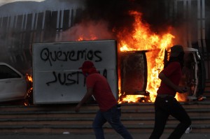 Student teachers burn a vehicle during a protest in support of the missing students of Ayotzinapa Teacher Training College Raul Isidro Burgos outside the government palace of Guerrero state in Chilpacingo